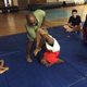 Changa Bell assists a student in scorpion pose